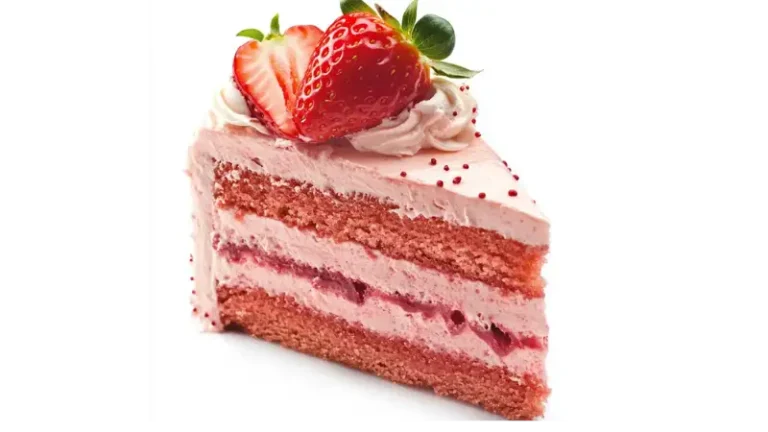 A slice of strawberry layer cake with creamy pink frosting, topped with a fresh strawberry cut in half, on a white background.