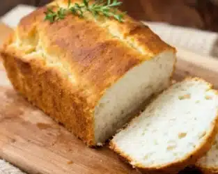 Freshly baked cottage cheese bread on a cutting board.