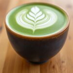 Close-up of a matcha latte in a ceramic cup.